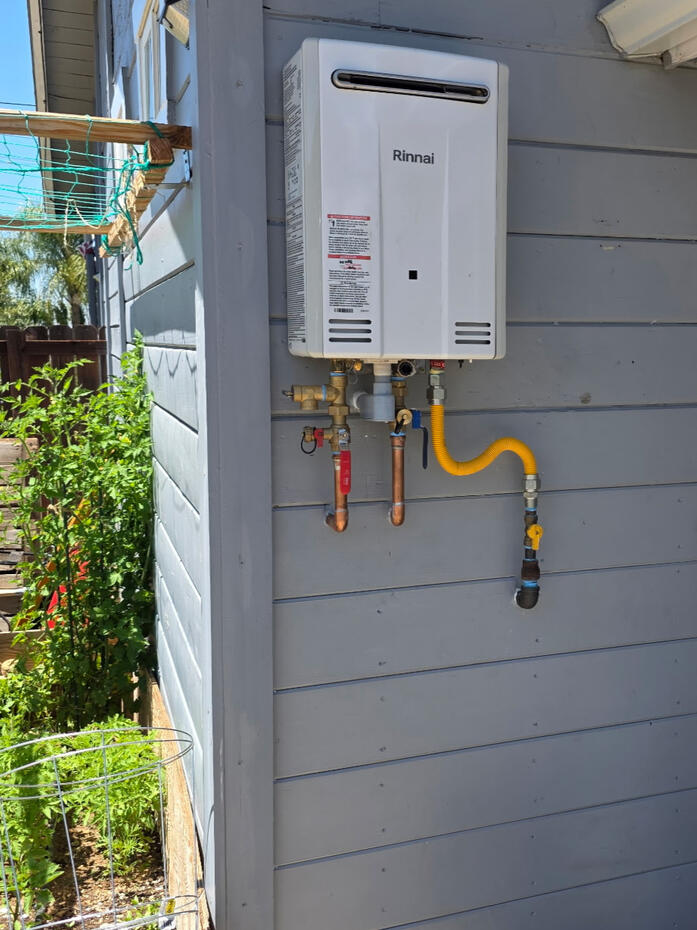 Water heater installation and plumbing work completed as part of a home improvement project.